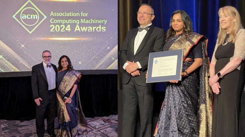 Awards ceremony with people standing next to each other during presentation